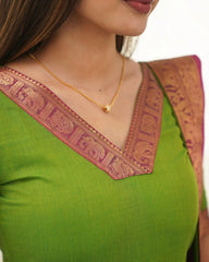 Green blouse with pink and gold border and gold necklace