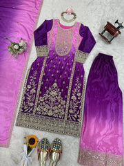 Purple embroidered outfit with pink dupatta on a textured surface
