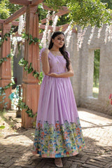 Woman wearing a purple dress with a floral skirt in an outdoor setting