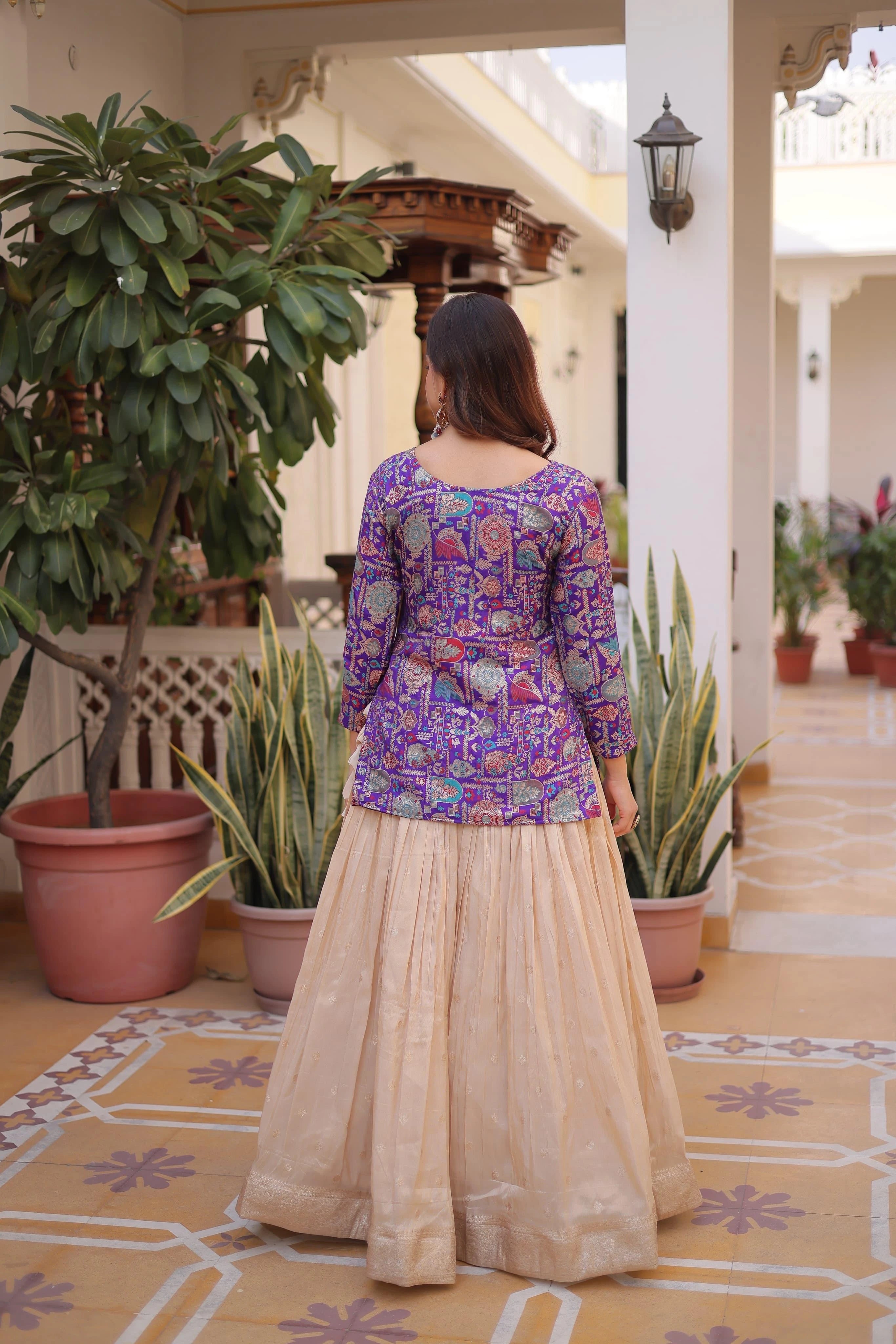 Woman in a colorful traditional outfit standing in a decorated indoor setting with plants.