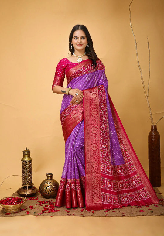 Woman wearing a purple and red saree with a beige background