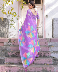 Woman in a colorful saree standing on steps outdoors
