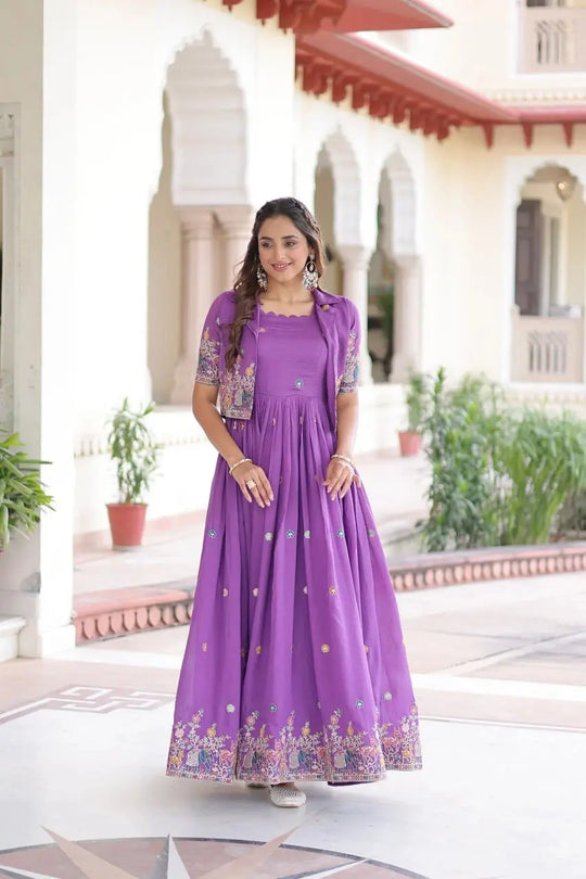 Woman in a purple dress standing in front of a building with arches and plants.