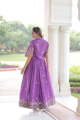 Woman in a purple dress standing in a garden setting