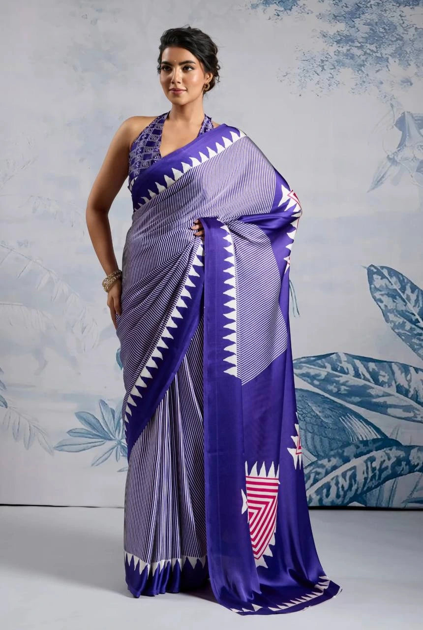 Woman wearing a purple and white saree with a blue leafy pattern in the background