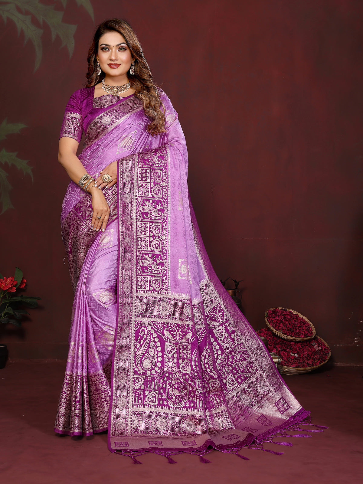 Woman wearing a purple saree with intricate patterns on a dark background
