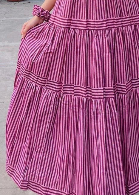 Close-up of a pink and white striped dress with a tiered skirt.
