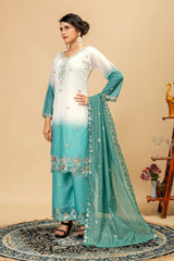 Woman wearing a white and turquoise embroidered outfit with a beige background
