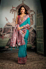 Woman in a traditional saree standing in front of an ornate backdrop
