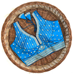 Blue embroidered blouse with a matching dupatta on a woven basket