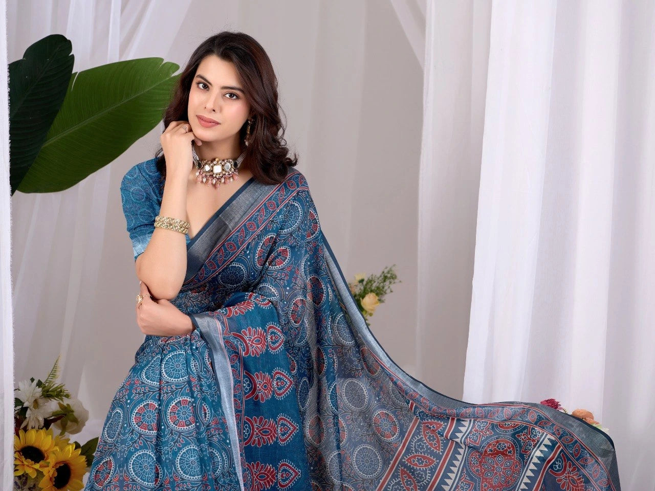 Woman wearing a blue saree with a white background