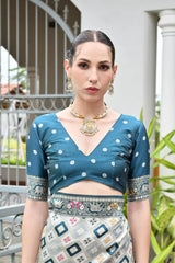Luxurious Rama blue soft silk saree folded neatly, showcasing fine zari weaving details