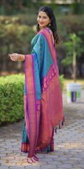 Woman wearing a colorful saree outdoors on a paved path with greenery.