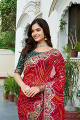 Red Gota Patti Saree styled with flared pleats against palace pillar