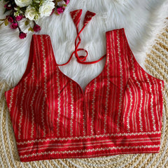 Red Zari Work Silk Blouse with intricate embroidery, perfect for festive and traditional occasions.