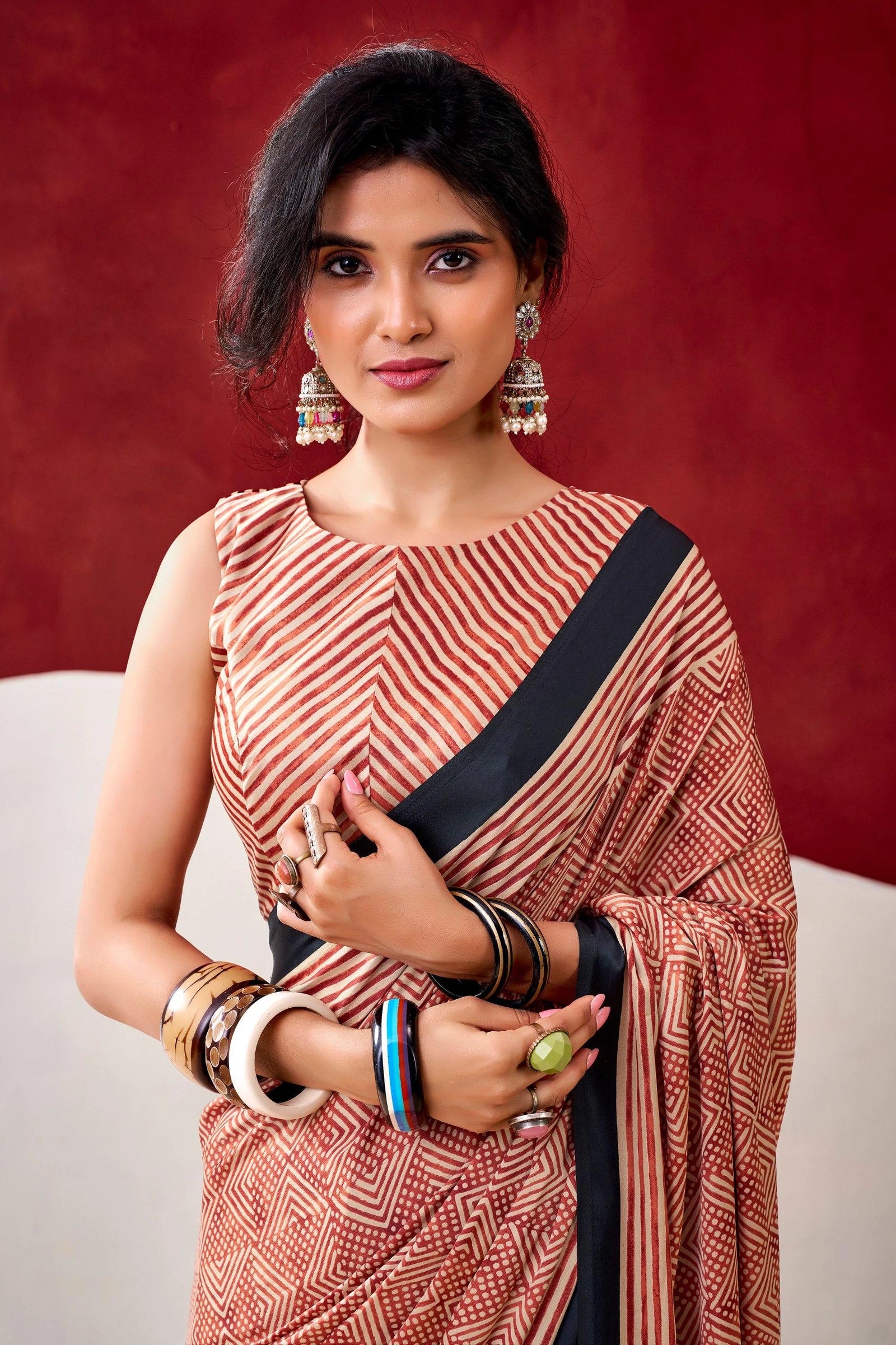 Woman wearing a traditional saree with a red background