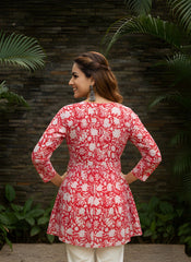 Red cotton short kurti with vibrant digital floral print, round neckline, and 3/4th sleeves — stylish casual wear for everyday comfort