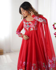 Woman wearing a red floral dress with a white background