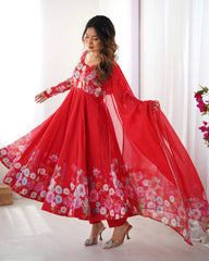 Woman wearing a red floral dress with a flowing skirt in a bright room.