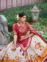Woman in traditional Indian attire with floral patterns in a garden setting