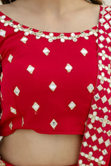 Red blouse with white diamond patterns and embellishments