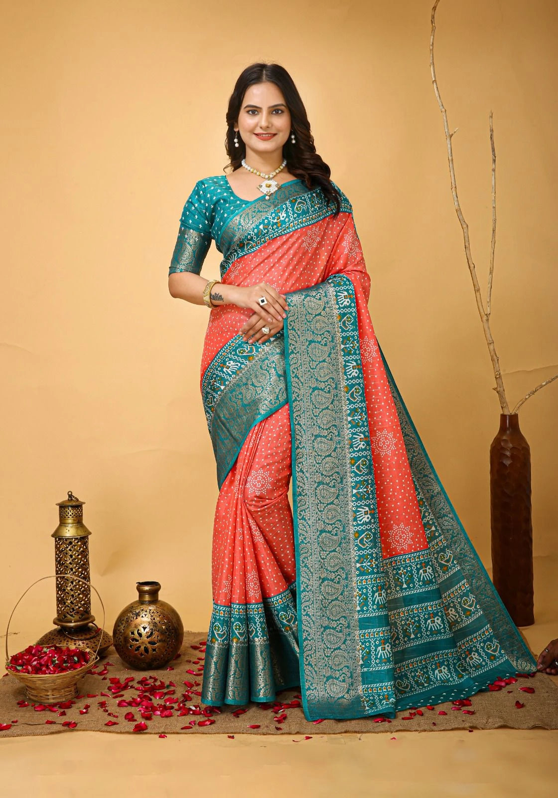 Woman wearing a pink and blue saree with decorative elements on a beige background