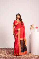Woman wearing a red saree with gold border in a minimalistic setting