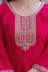 Close-up of a red garment with intricate gold embroidery