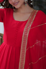 Red dress with gold embroidery on a blurred background