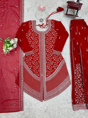 Red embroidered outfit with white patterns on a textured surface