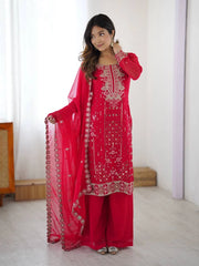 Woman wearing a red embroidered traditional outfit with a white background