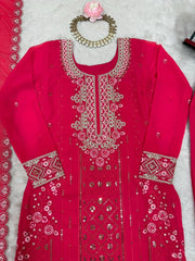 Red embroidered traditional outfit with jewelry on a light gray background