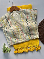 Textile with zigzag pattern and yellow tassels on a gray background