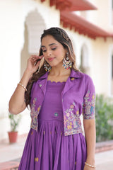 Woman wearing a purple dress with floral embroidery outdoors