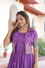Woman wearing a purple dress with floral embroidery outdoors