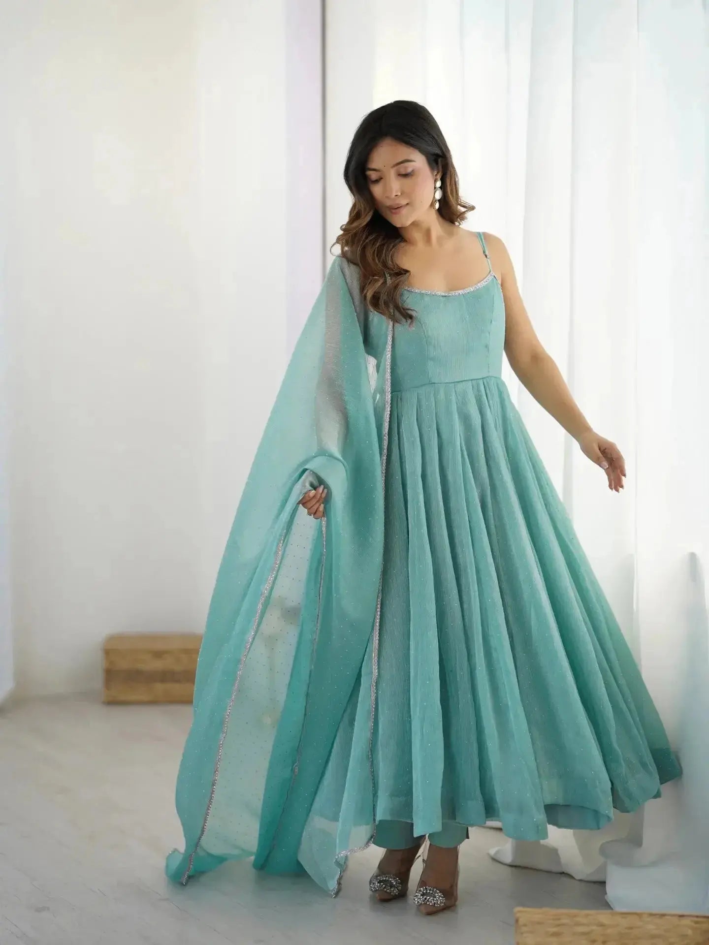 Sky blue Swarovski anarkali suit, profile view with dupatta drape