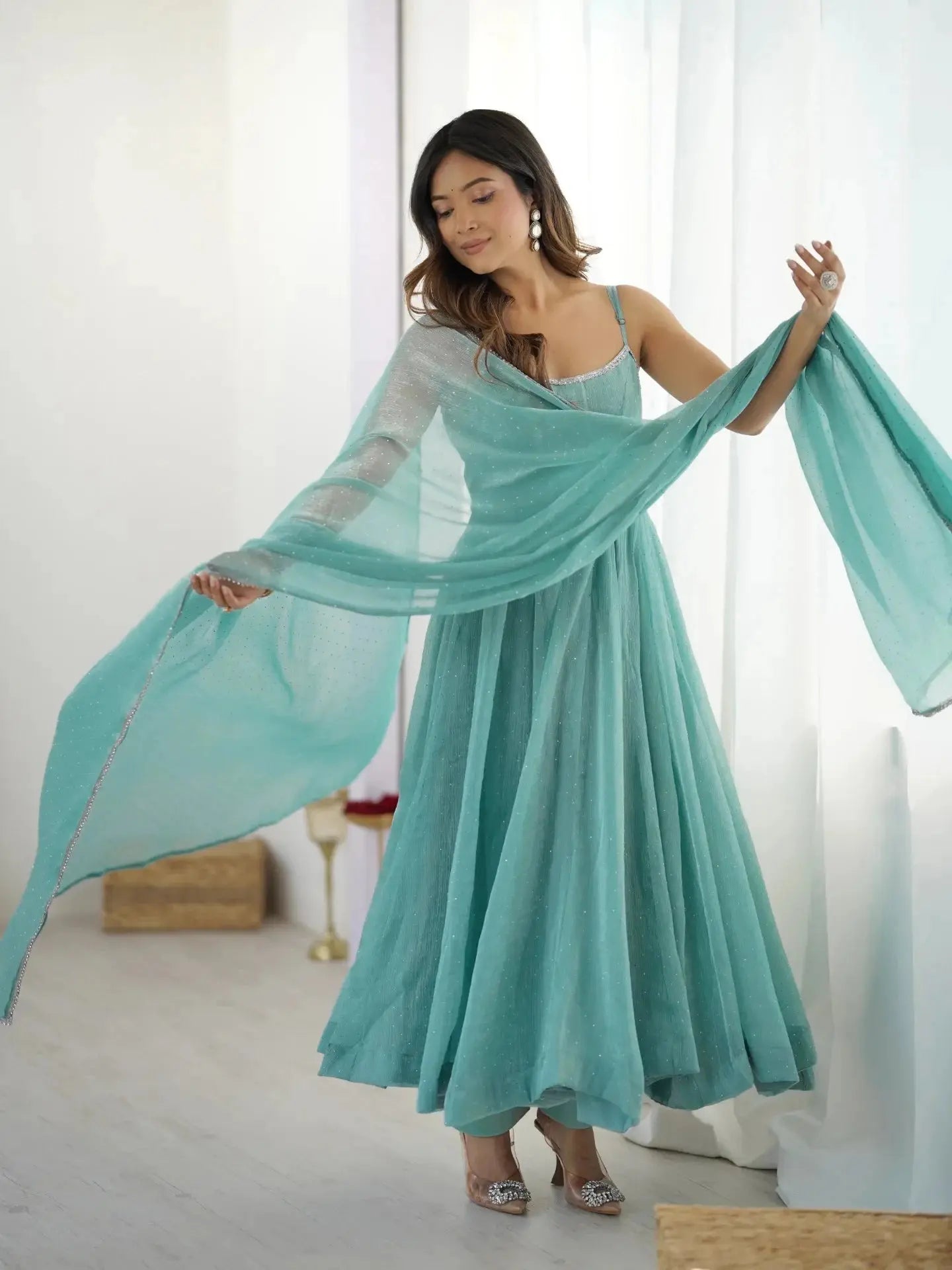 Sky blue Swarovski anarkali suit, side view showing flare