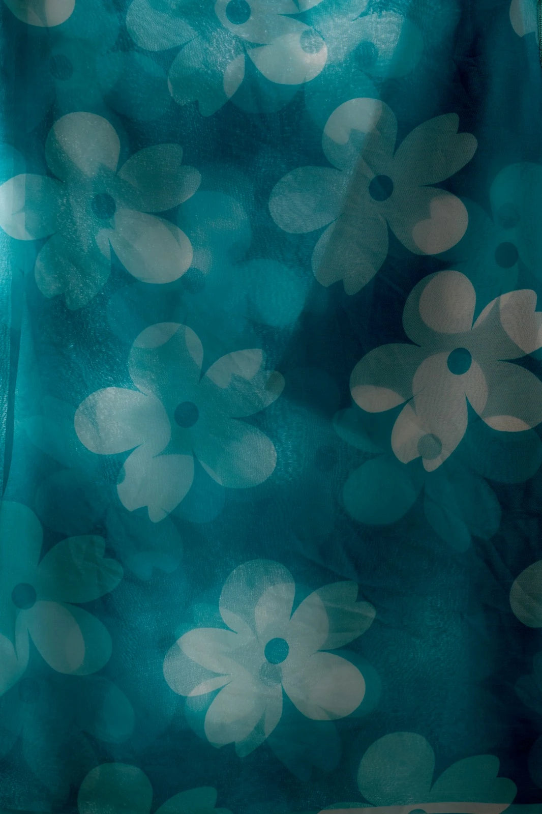 Teal fabric with white floral patterns