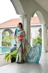 Woman in a floral saree standing on a porch with a pool and garden in the background