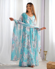 Woman wearing a floral dress with a light blue and white pattern in a bright room.