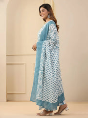 Woman wearing a blue and white patterned dress in an indoor setting