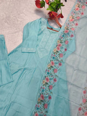 Light blue traditional outfit with floral embroidery on a light gray background
