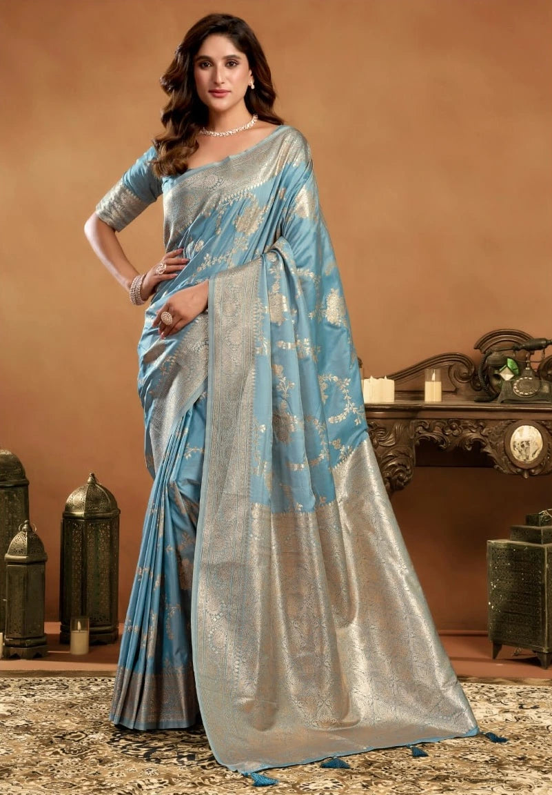 Woman wearing a blue and gray saree in an elegant indoor setting