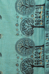 Teal fabric with black tree and people pattern