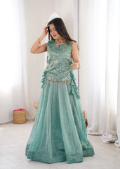 Woman wearing a Sky Blue traditional outfit with white curtains in the background