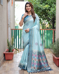 Woman wearing a light blue saree with a patterned border on a balcony.