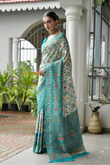Sky blue Banarasi silk saree with golden zari weaving displayed on mannequin.