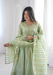 Close-up portrait of mirror work neckline and cuff on pastel green anarkali suit