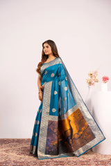 Woman wearing a blue saree with a white background