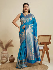 Woman wearing a blue saree with a floral pattern in a minimalistic setting